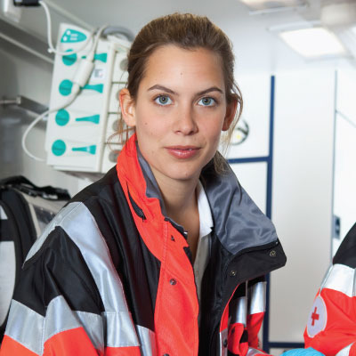 EMT in an ambulance looking at camera