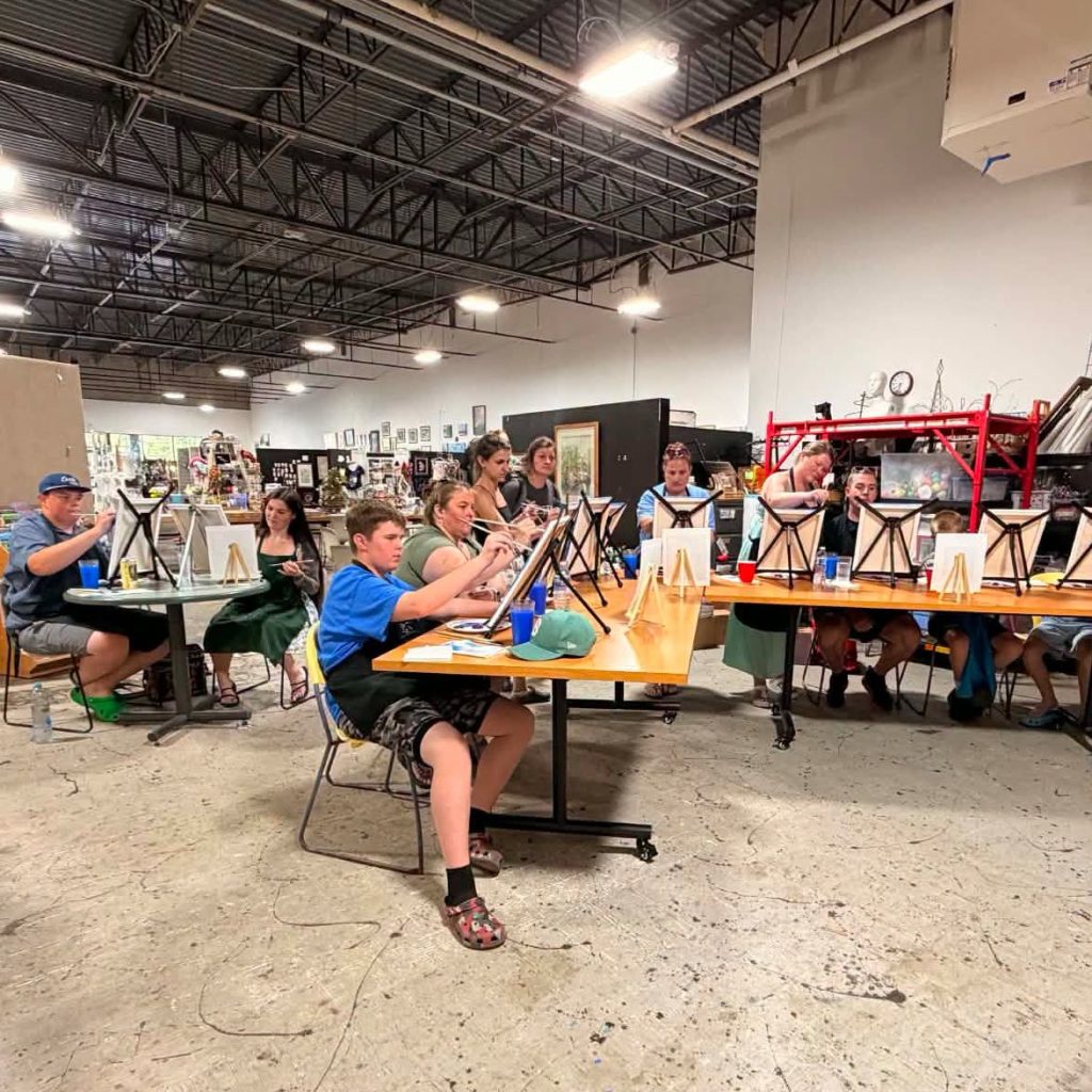 Group of first responders and their families at a paint and sip event